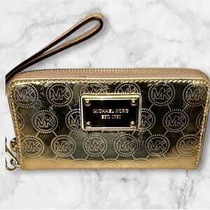 Michael Kors Jet Set Zip Around Wallet in gold patent leather with embossed logo